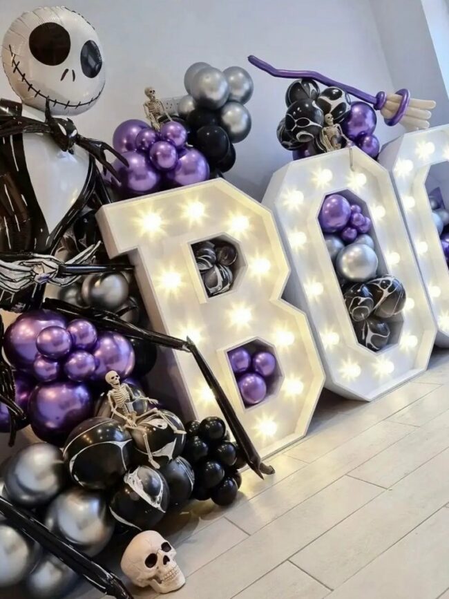 Halloweenská dekorace s balónky ve fialové, černé a stříbrné barvě.